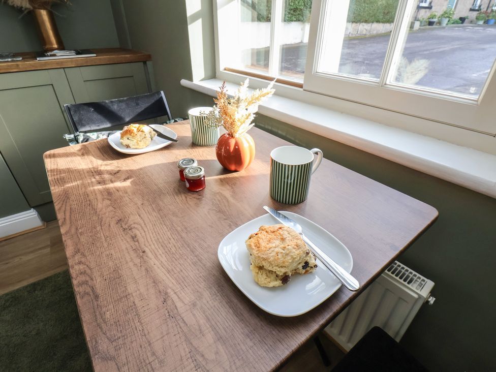 A dining room with a table set for two at Chimes Cottage in Guisborough