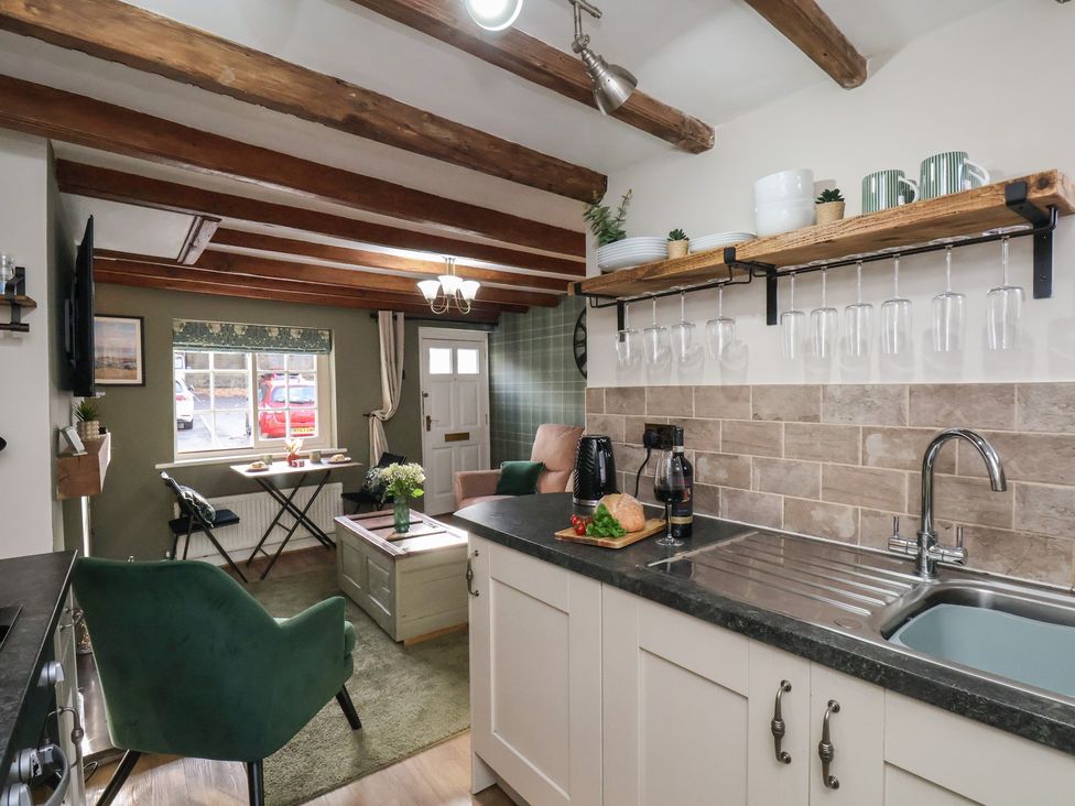 A kitchen with sink and storage at Chimes Cottage in Guisborough
