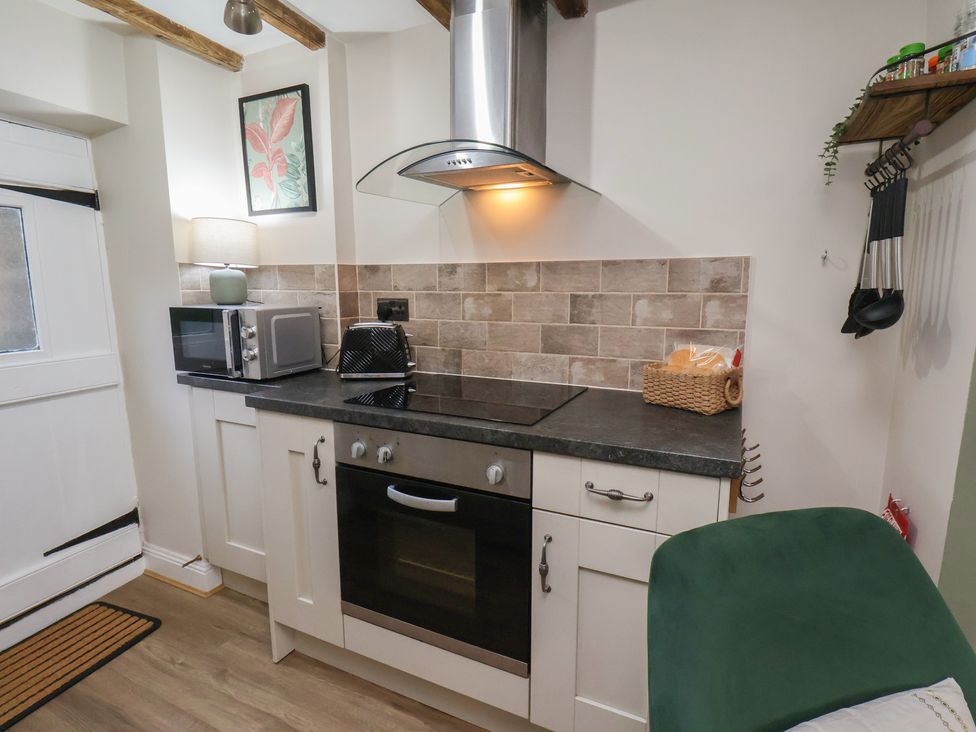 A kitchen with an oven and microwave at Chimes Cottage in Guisborough