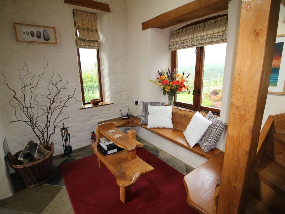 A snug with wooden bench and vase at The Dovecote in Fishguard