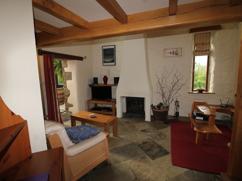 A living room with a sofa and coffee table at The Dovecote in Fishguard