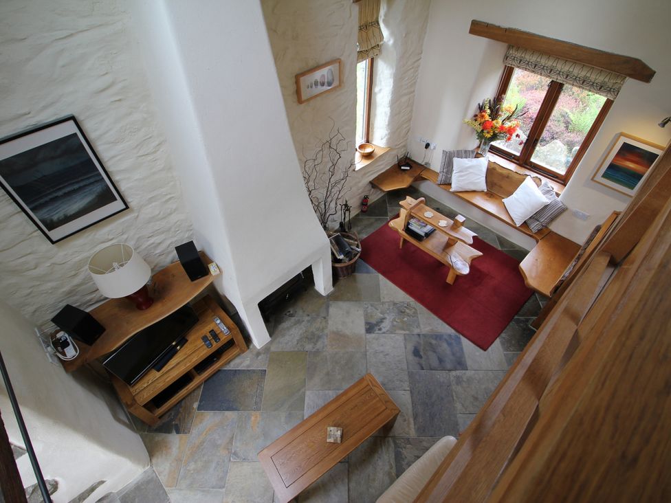 A living room with a sofa and coffee table at The Dovecote in Fishguard