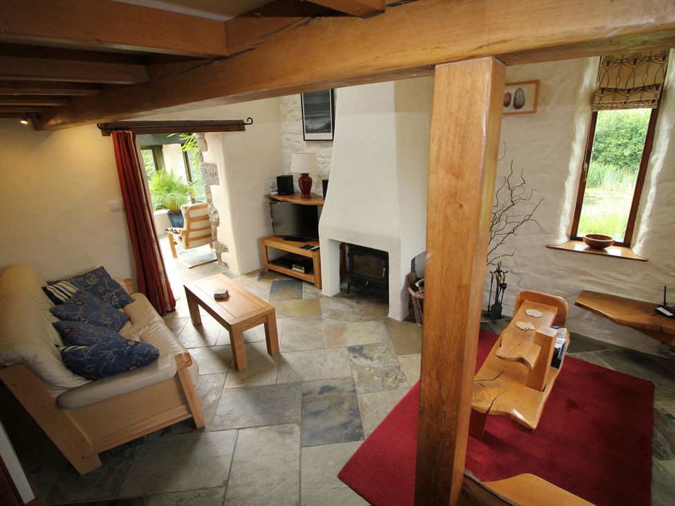 A living room with a sofa and coffee table at The Dovecote in Fishguard