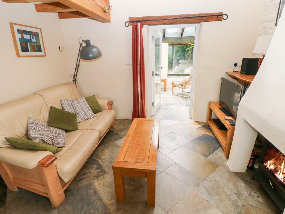 A living room with a sofa and coffee table at The Dovecote in Llanychaer near Fishguard