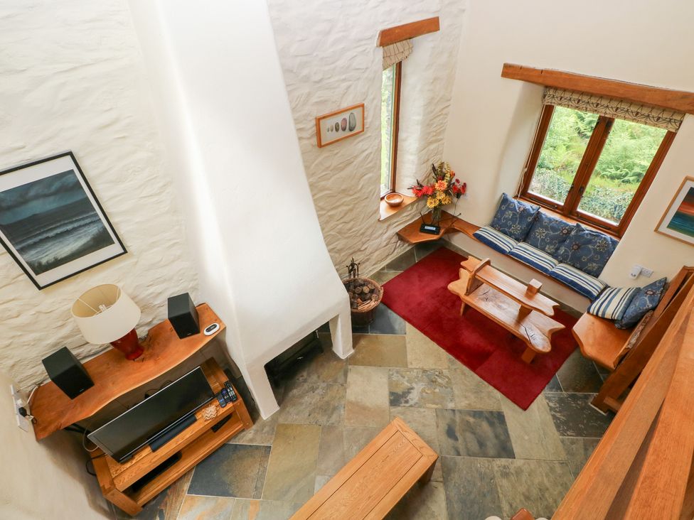 A living room with a sofa and coffee table at The Dovecote, Llanychaer near Fishguard