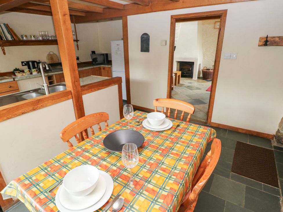 A kitchen with a dining table and chairs at The Dovecote Llanychaer near Fishguard
