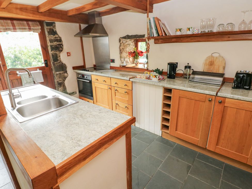 A kitchen with cabinets and a countertop at The Dovecote in Llanychaer near Fishguard