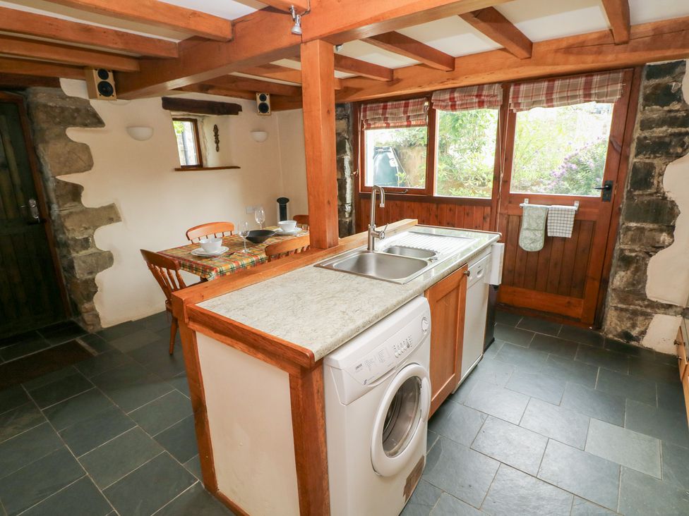 A kitchen with a sink and washing machine at The Dovecote Llanychaer near Fishguard