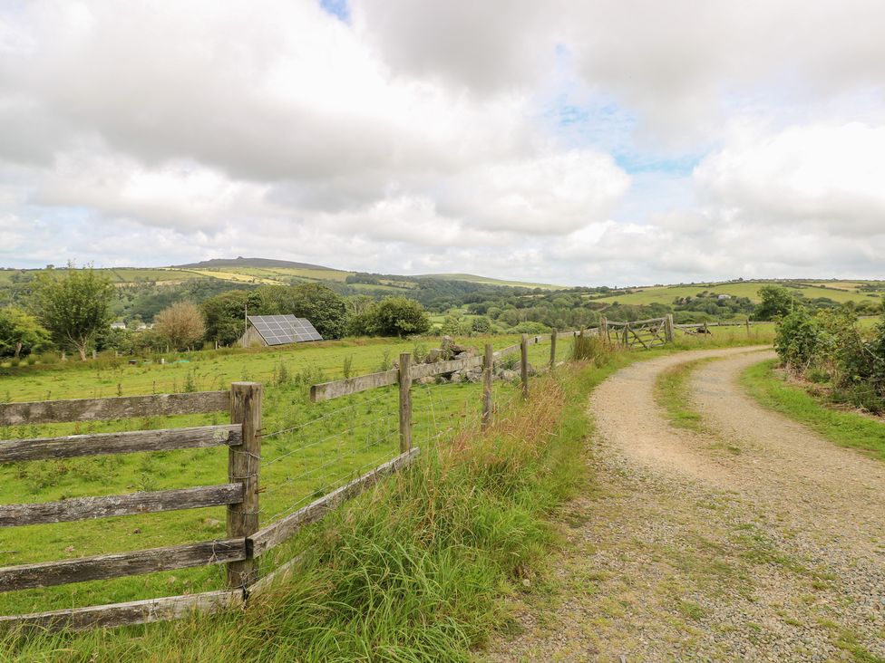 A pathway leading through a field with a fence and solar panels at The Dovecote Llanychaer near Fishguard
