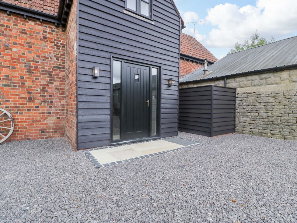 An outdoor area with a front door and gravel at The Sty near Shades Farm near Malmesbury