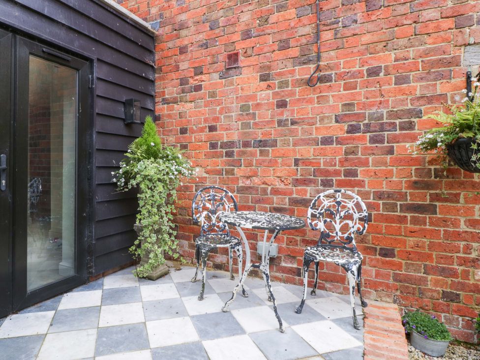 An outdoor area with a table and chairs at The Sty near Malmesbury