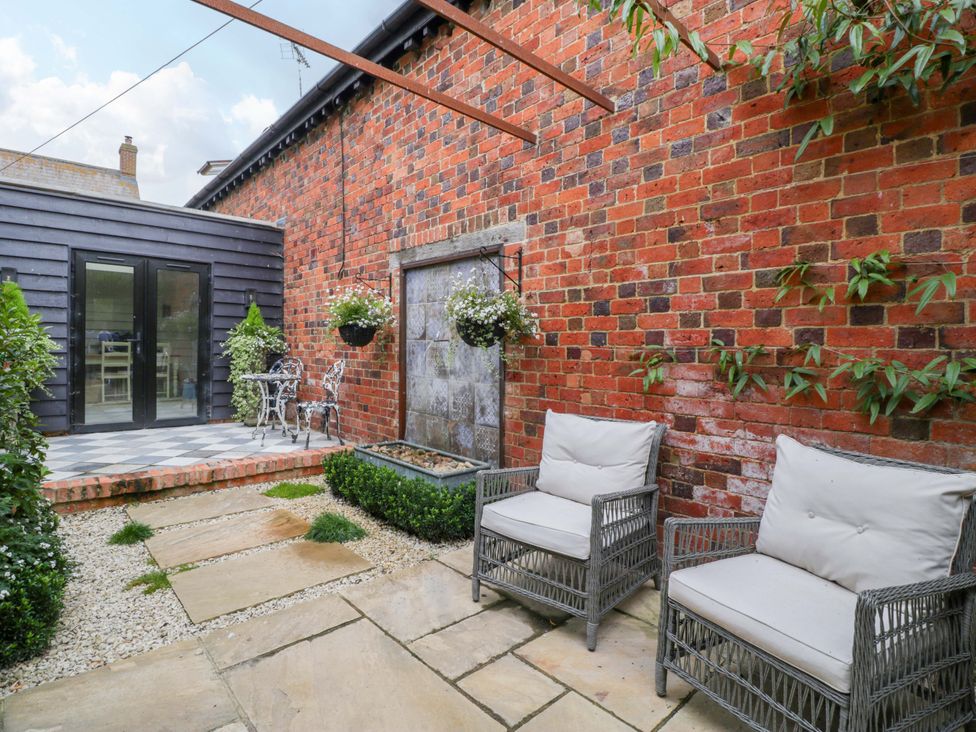 A garden with seating area and water feature at The Sty near Shades Farm near Malmesbury