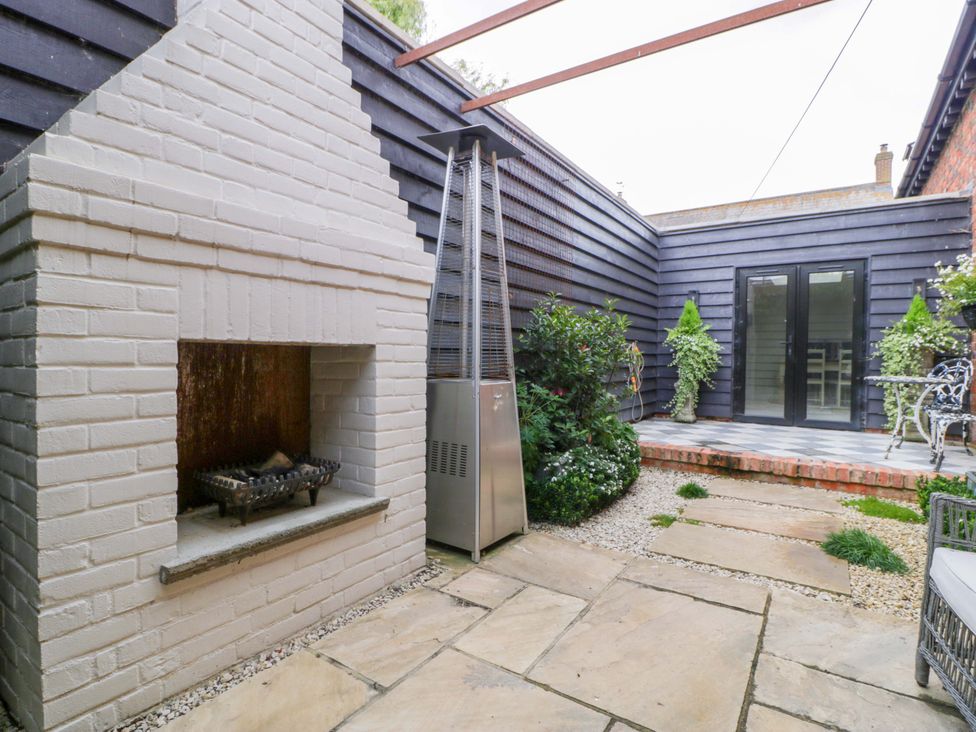 A garden featuring an outdoor fireplace and patio heater at The Sty near Shades Farm near Malmesbury