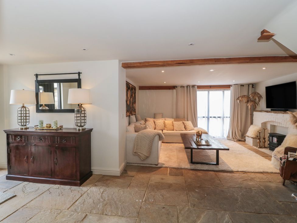 A living room with a sofa and coffee table at The Sty, Shades Farm near Malmesbury