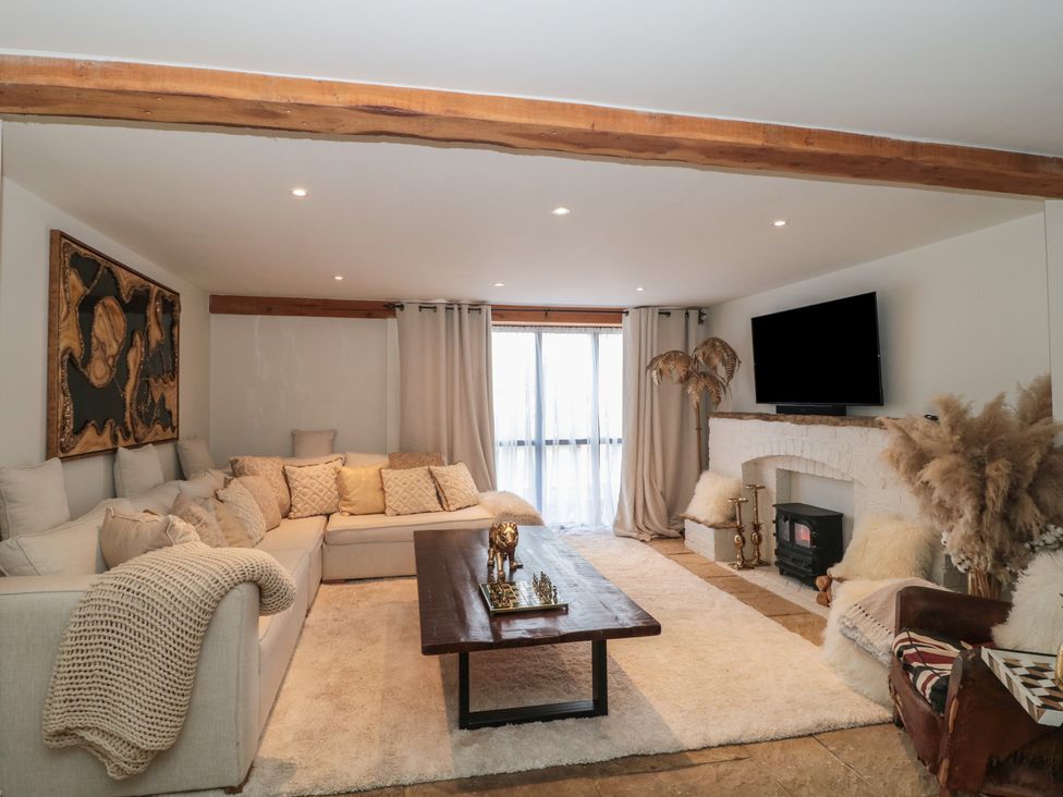 A living room with a sofa and coffee table at The Sty near Shades Farm near Malmesbury
