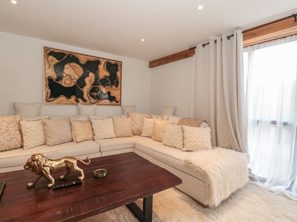 A living room with a sofa and table at The Sty near Shades Farm in Malmesbury