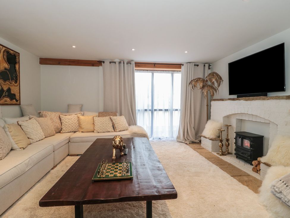 A living room with a sofa and coffee table at The Sty near Malmesbury