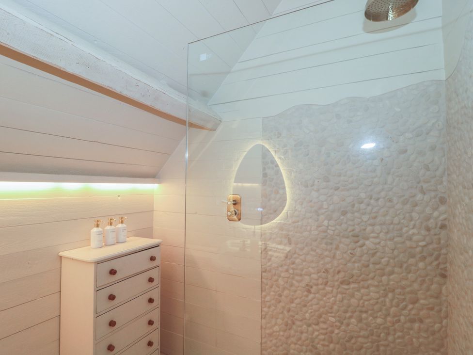 A bathroom with a shower and vanity at The Sty near Malmesbury
