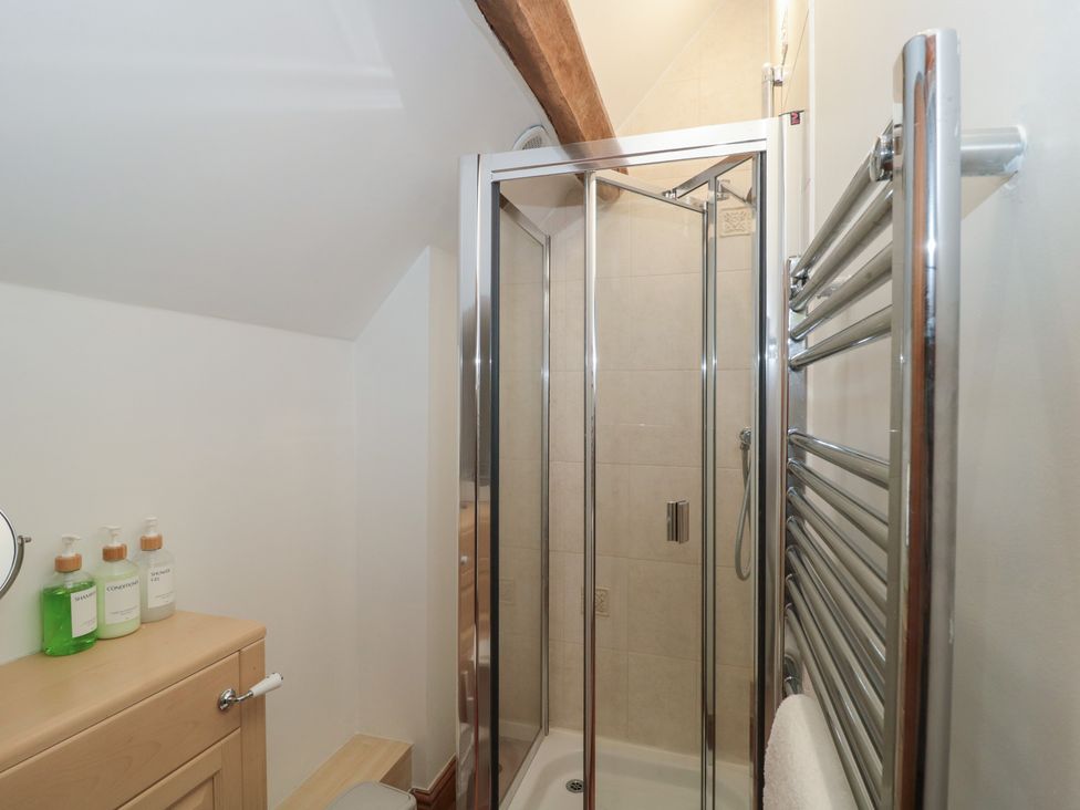 A bathroom with a shower and towel radiator at The Sty, Shades Farm near Malmesbury