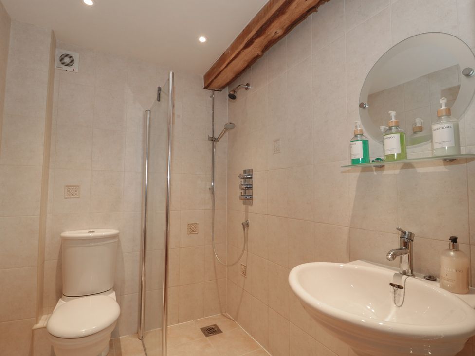 A bathroom featuring a shower, toilet, and sink at The Sty, Shades Farm near Malmesbury