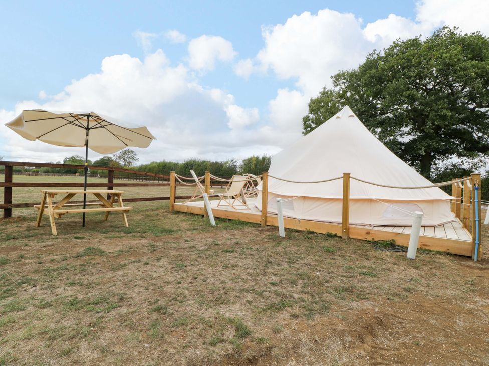 An outdoor area with a tent and picnic table at Bell 1 near Shades Farm near Malmesbury