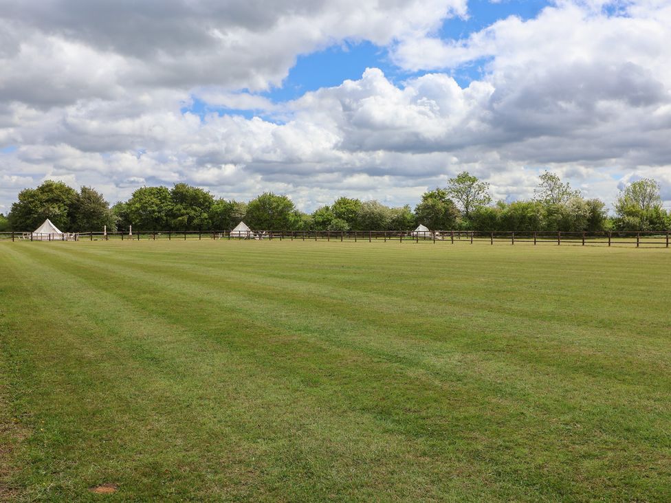 An outdoor space with grass and tents at Bell 1 Shades Farm near Minety