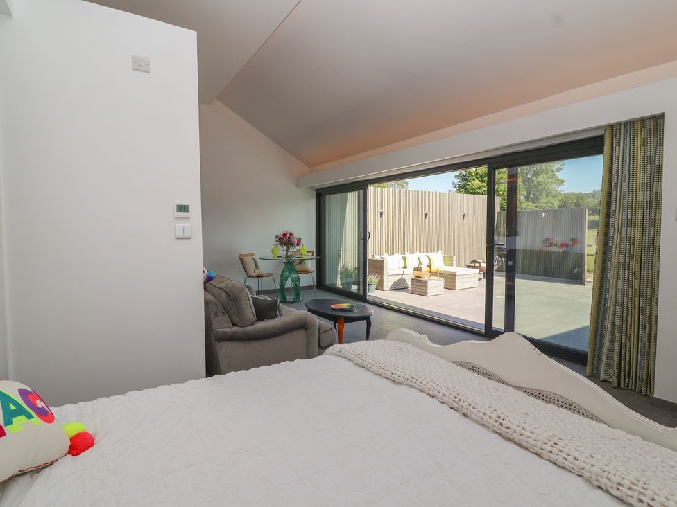 A bedroom with a view of an outdoor seating area at Noflash Malpal in Bristol