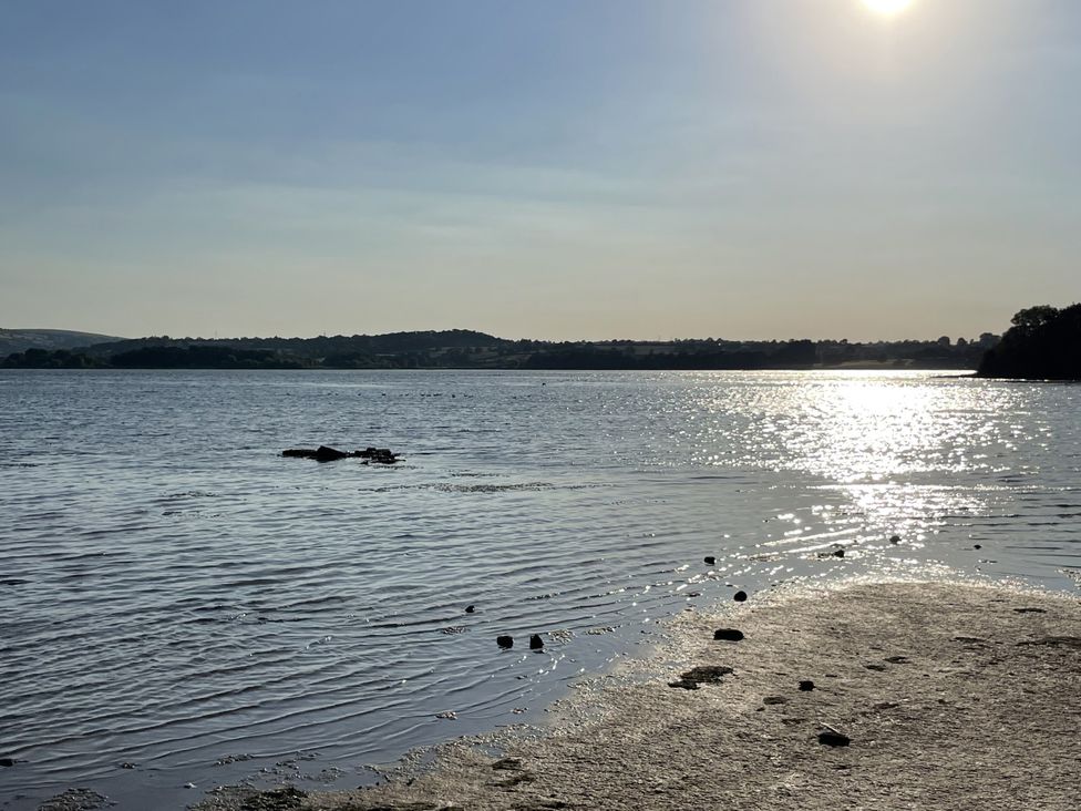 A landscape view of water and sun reflection at Noflash Malpal in Bishop Sutton