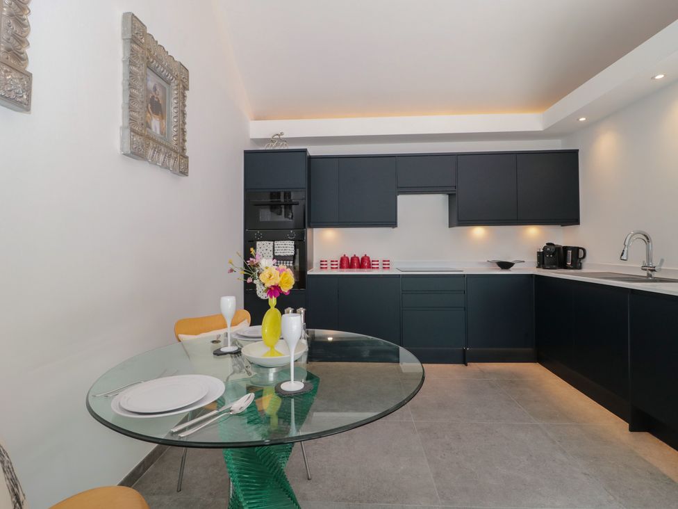 A kitchen with a dining table and chairs at Noflash Malpal in Bishop Sutton