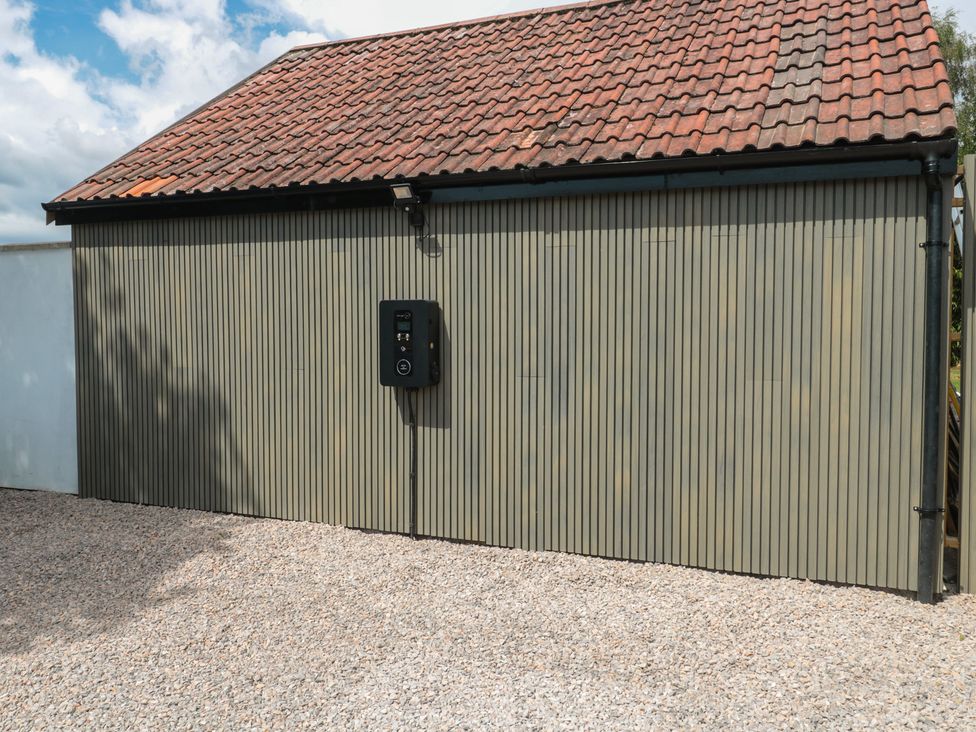A building exterior with an electric vehicle charger at Noflash Malpal in Bishop Sutton