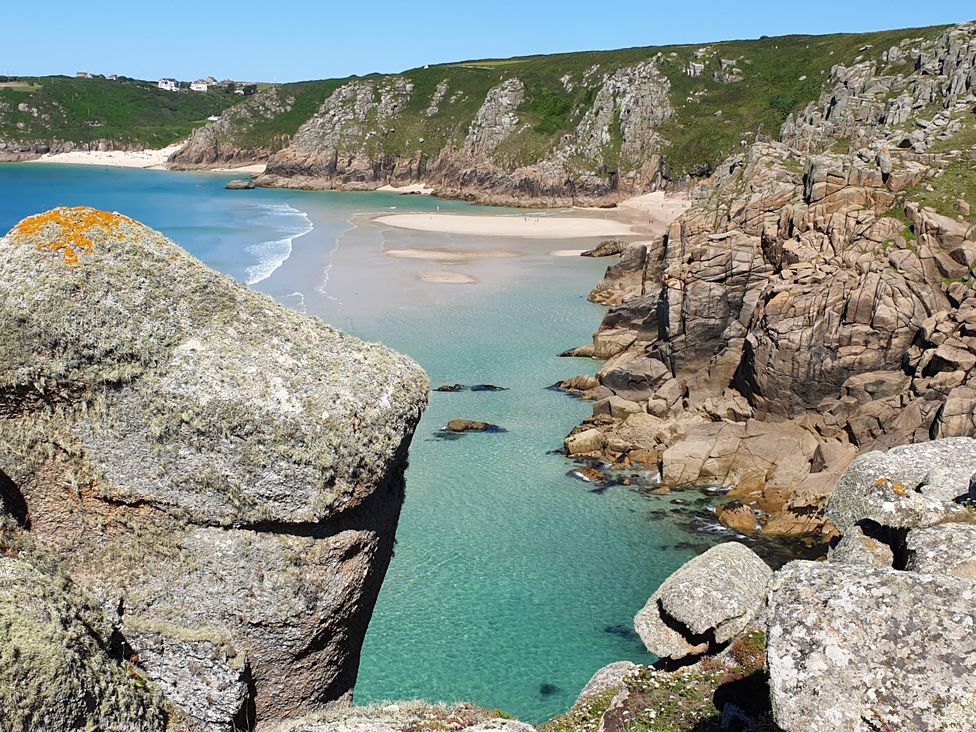 A beach with water and cliffs at Tater-Du in Porthcurno near Land’s End