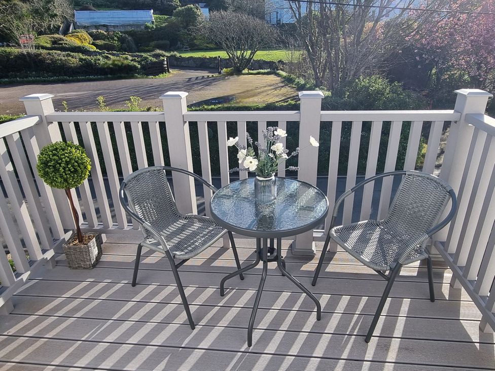 A patio with two chairs and a table at Tater-Du Porthcurno near Land’s End