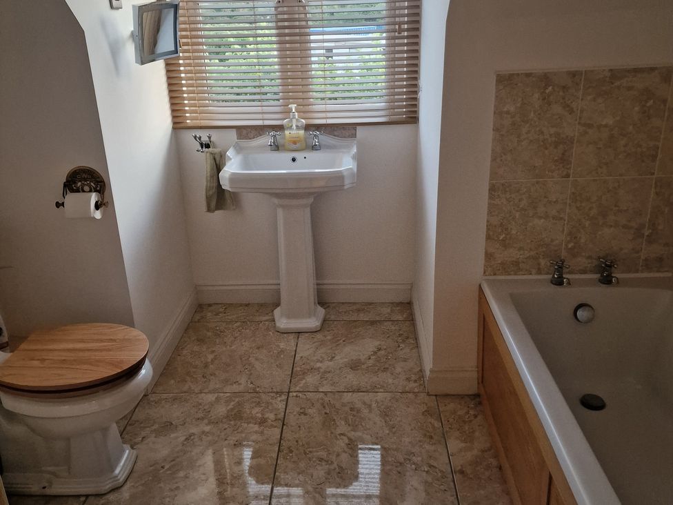 A bathroom with a toilet and a washbasin at The Mill House in Glastonbury