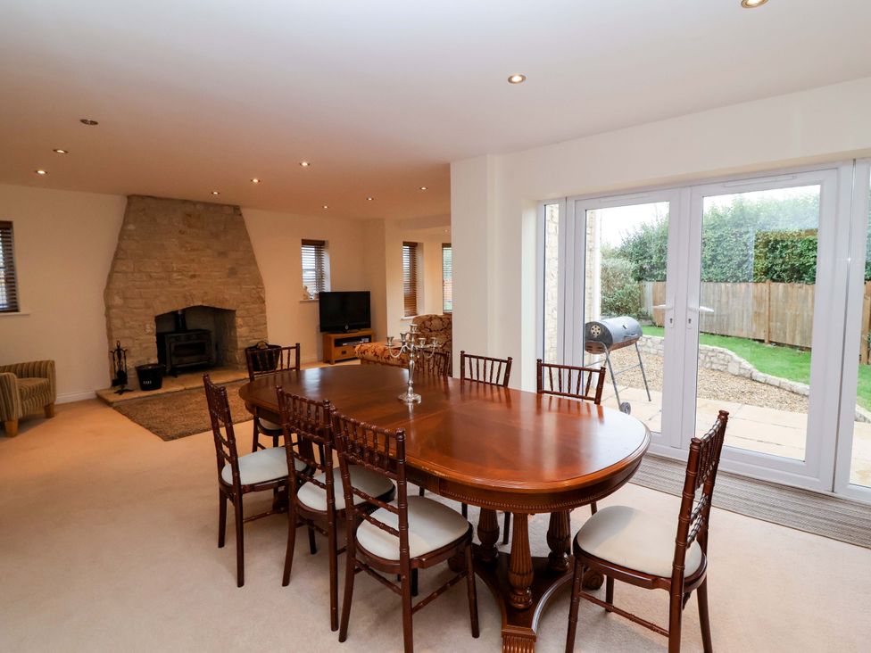 A dining room with a table and chairs at The Mill House in Glastonbury