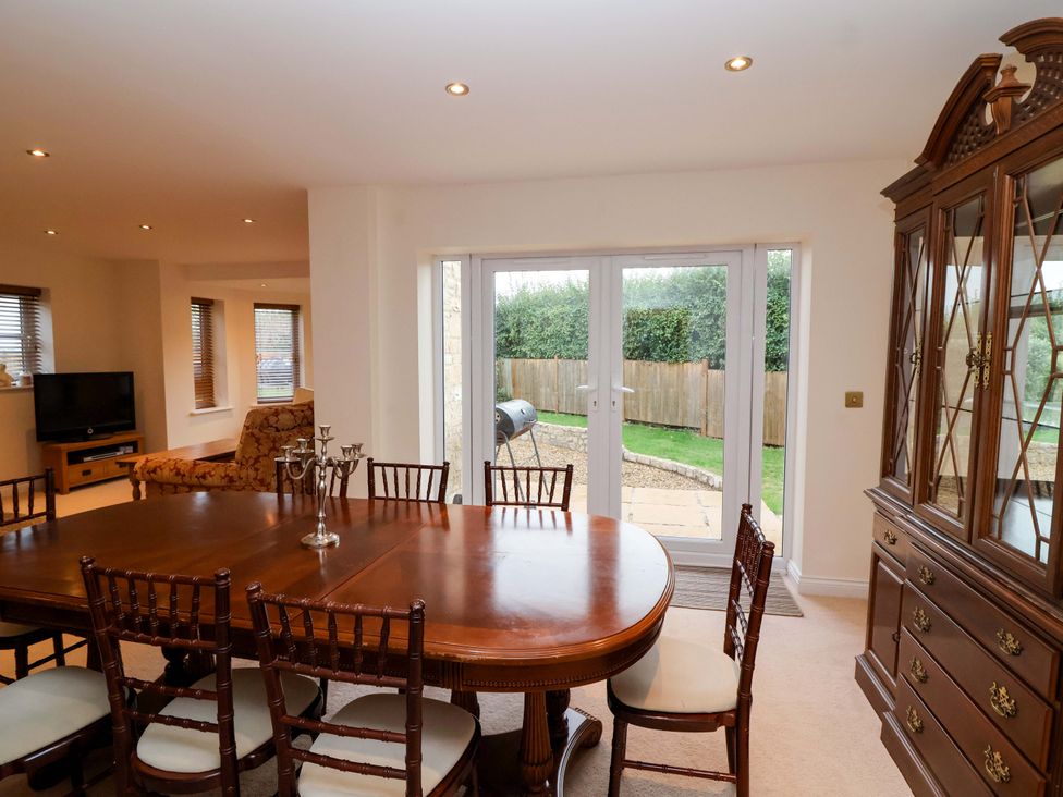 A dining room with a table and chairs at The Mill House in Glastonbury