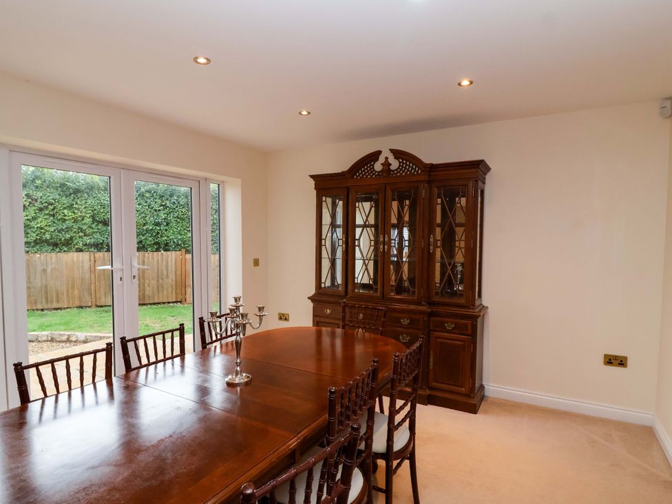A dining room with a table and chairs at The Mill House in Glastonbury