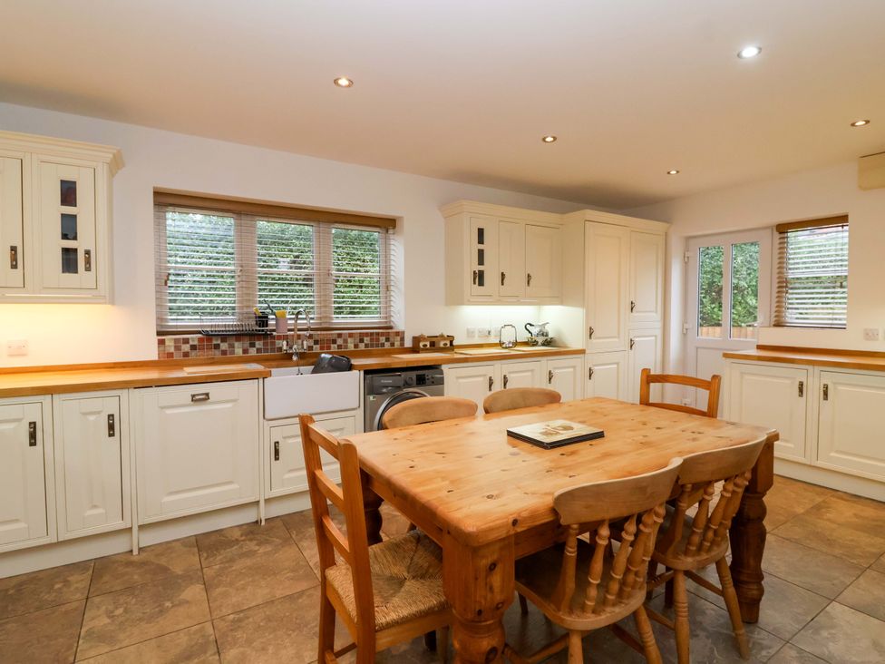 A kitchen with a table and chairs at The Mill House in Glastonbury
