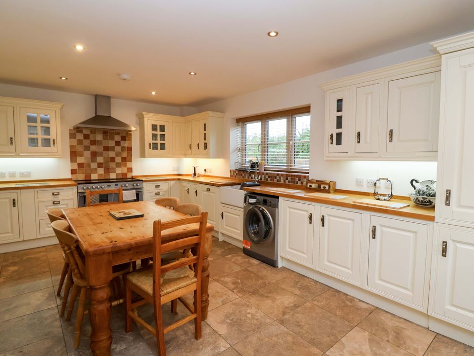 A kitchen with a table and chairs at The Mill House in Glastonbury
