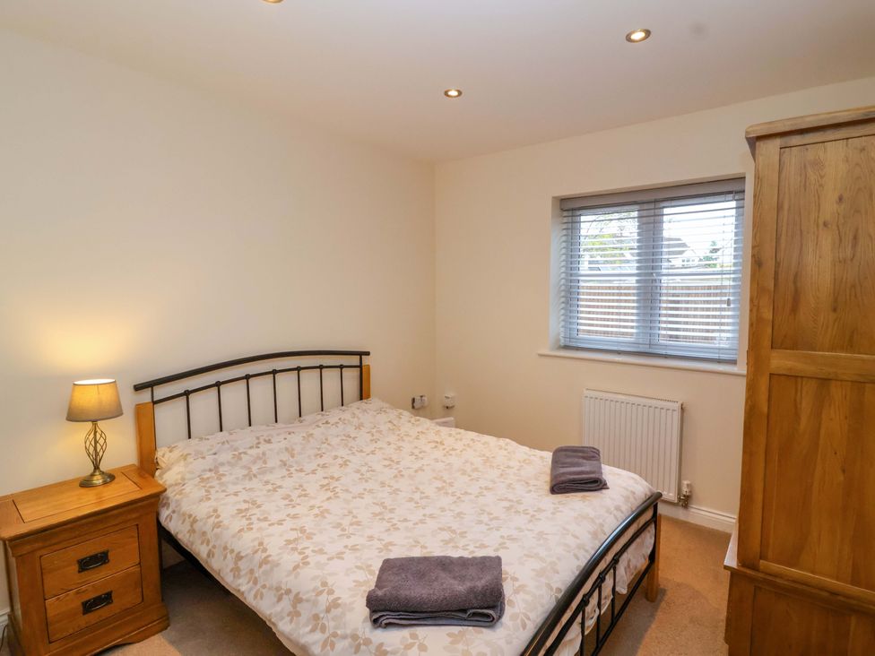 A bedroom with a double bed and a bedside table at The Mill House in Glastonbury