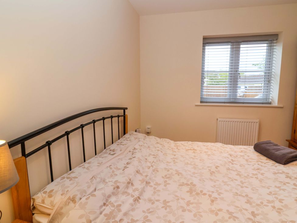A bedroom with a bed and window at The Mill House in Glastonbury