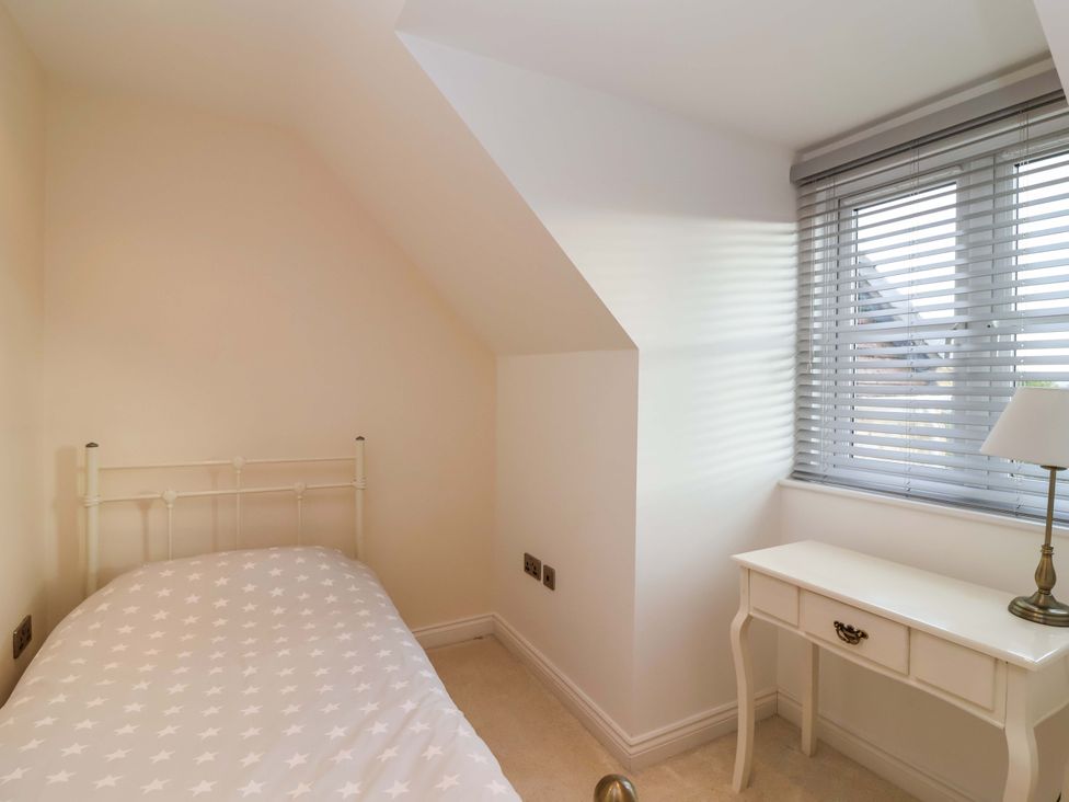 A bedroom with a bed and desk at The Mill House in Glastonbury