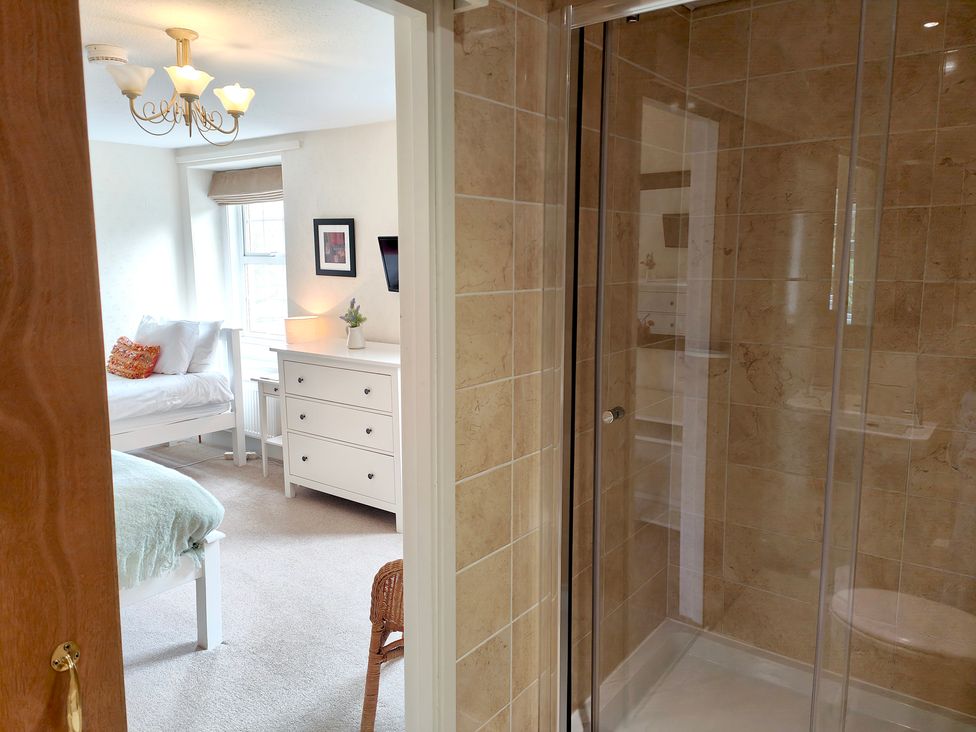 A bathroom with a shower and a view of a bedroom at Bush Nook House in Brampton