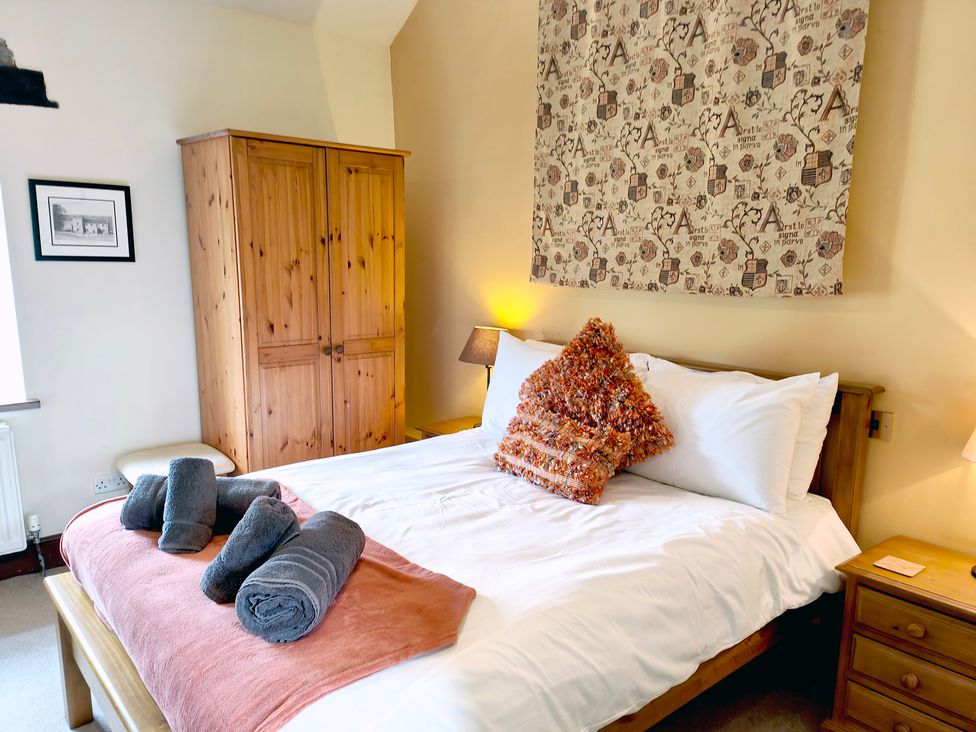 A bedroom with a bed and wardrobe at Bush Nook House in Brampton
