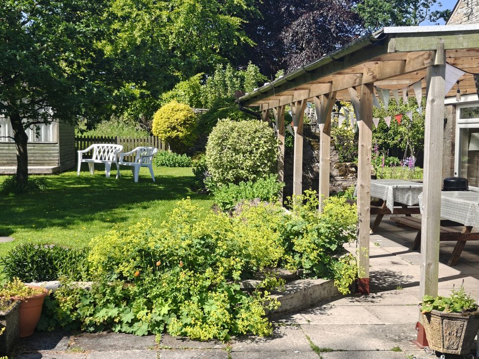 A garden with table and chairs at Bush Nook House Brampton, Cumbria