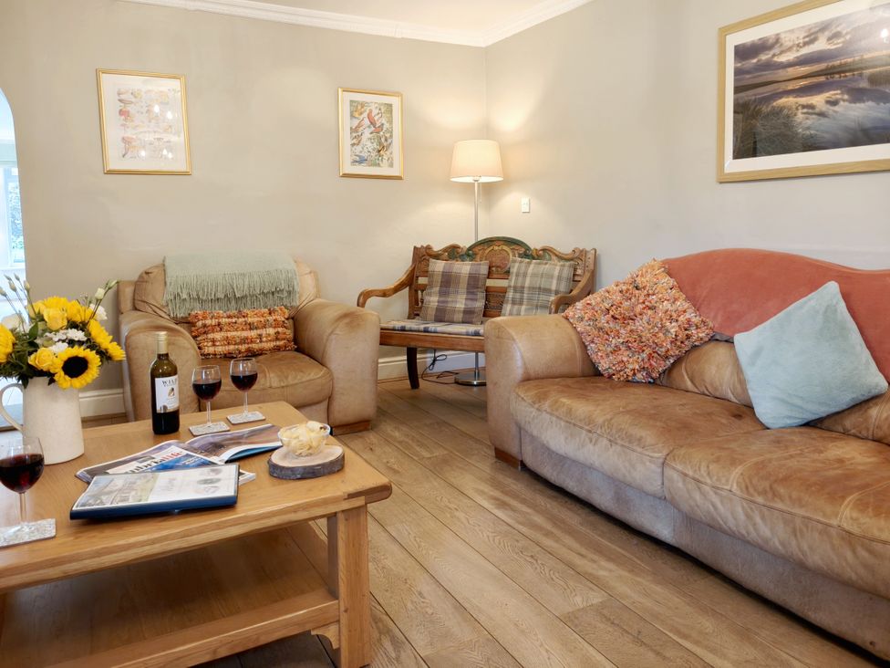 A living room with a sofa and armchair at Bush Nook House in Brampton, Cumbria