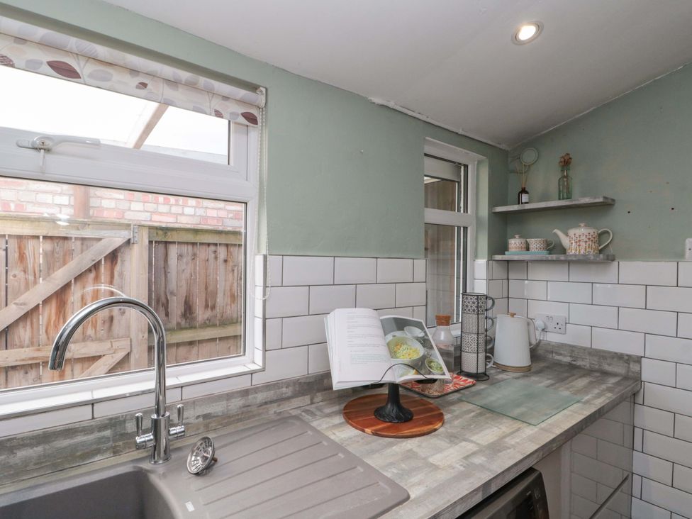 A kitchen with a sink and window at Moot Cottage in Driffield