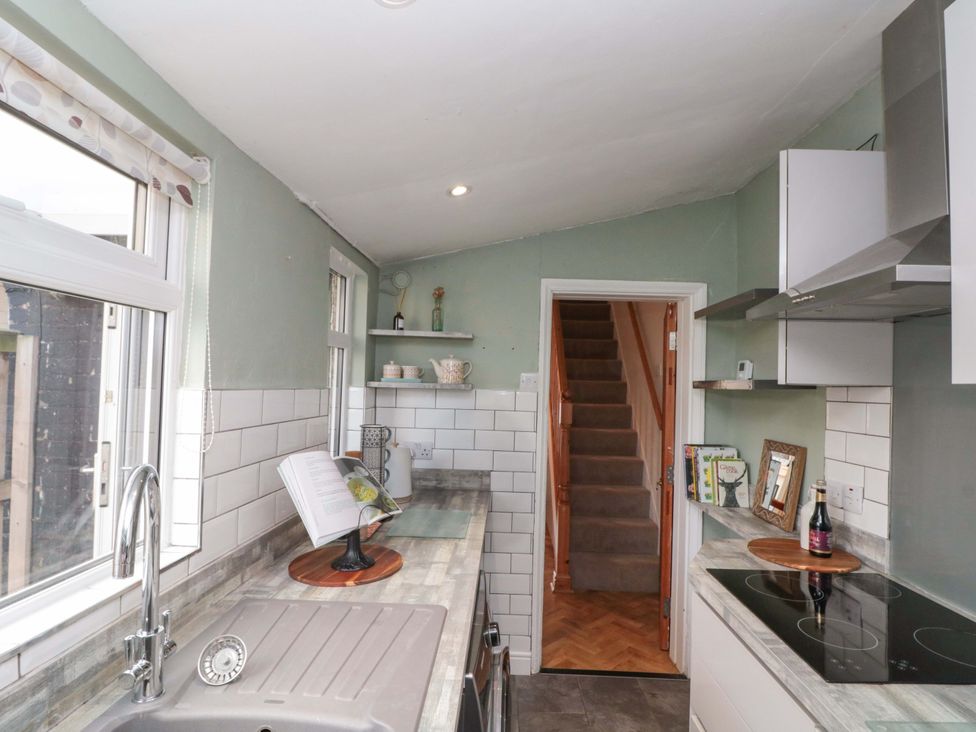 A kitchen with a sink and stove at Moot Cottage in Driffield