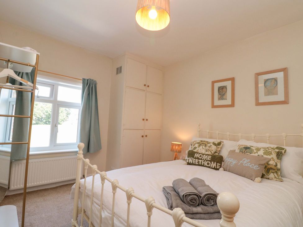A bedroom with a bed and window at Moot Cottage Driffield