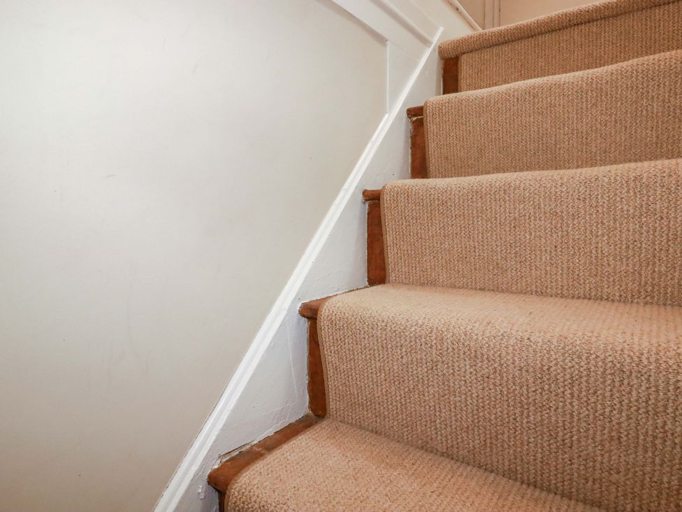 Stairs with carpet and wall at Sunnybrae Cottage in Tintagel