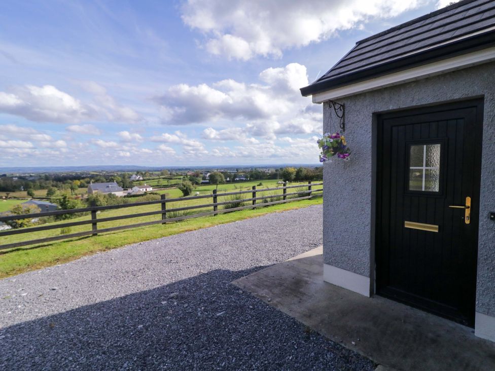 A view of a door with gravel path and landscape at Molly's Cottage Enniskillen